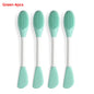 Four green silicone spoons on a white background