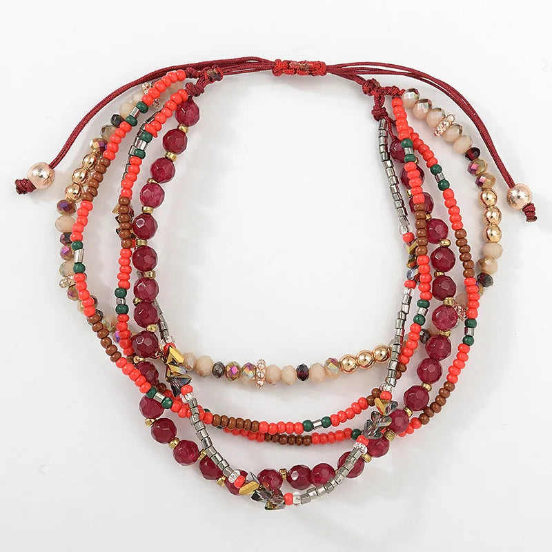 Stack of multicolored beaded bracelets on a white background