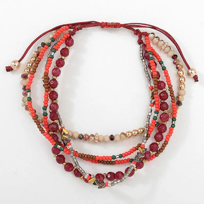 Stack of multicolored beaded bracelets on a white background