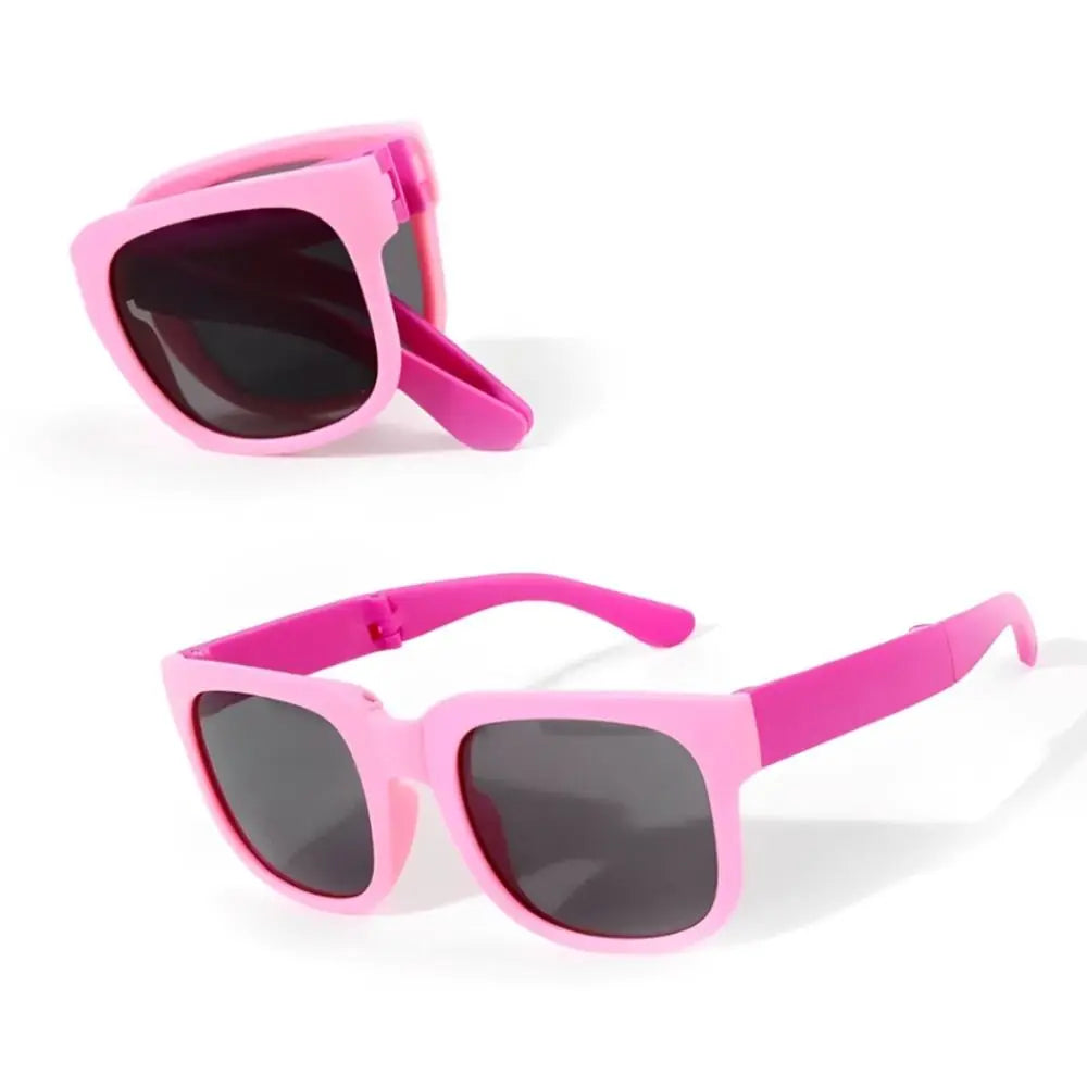 Pink sunglasses with dark lenses on a white background