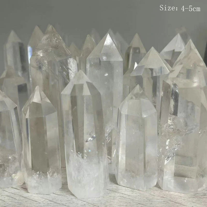 Clear crystal points on a wooden surface with a gray background