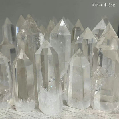 Clear crystal points on a wooden surface with a gray background