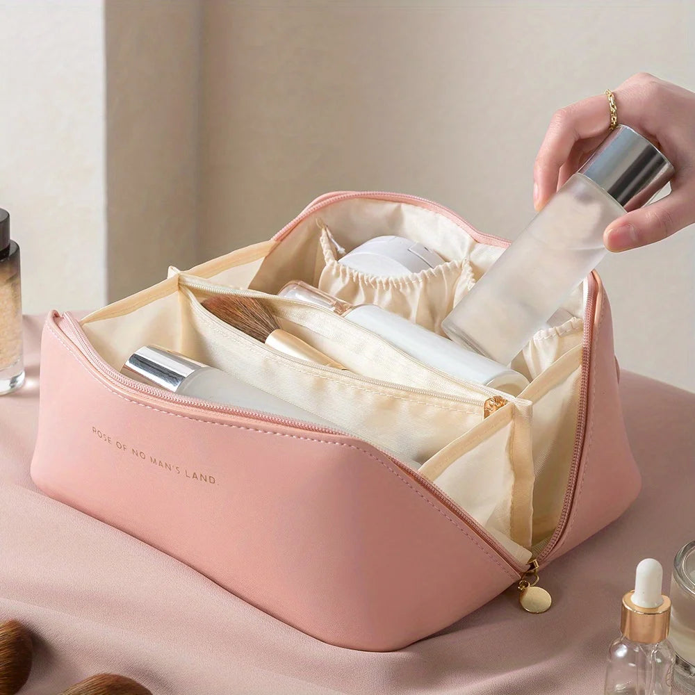 Pink cosmetic bag with skincare products on a neutral background
