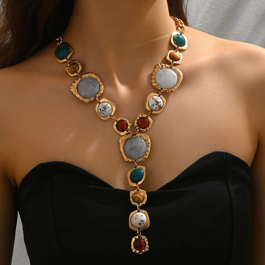 Necklace with multicolored stones on a model against a neutral background