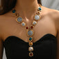 Necklace with multicolored stones on a model against a neutral background