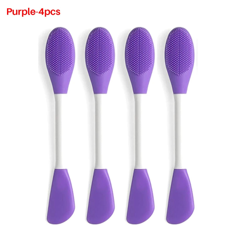 Four purple silicone spoons with textured ends on a white background
