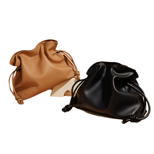 Brown and black leather drawstring bags on a beige background