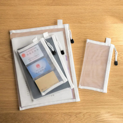 Set of photo sleeves with clear front and beige back on a wooden surface