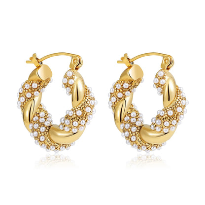 Gold hoop earrings with pearl accents on a white background