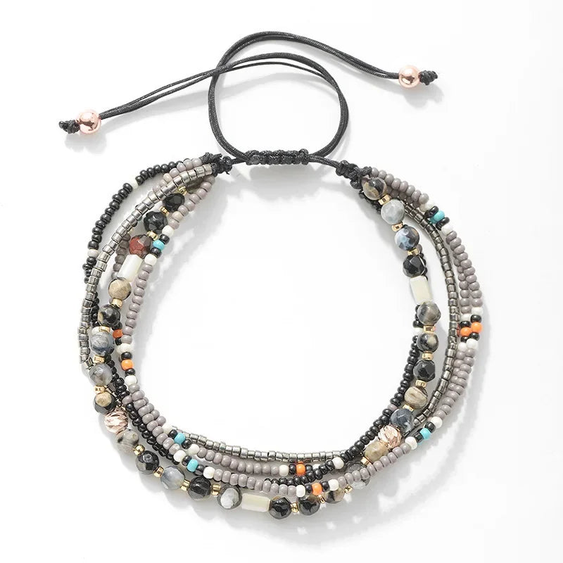 Multistrand beaded bracelet with various colored beads on a white background