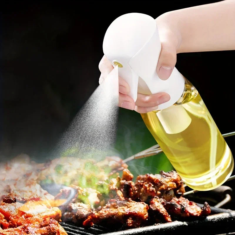 Person using a bottle of oil to spray on grilled food