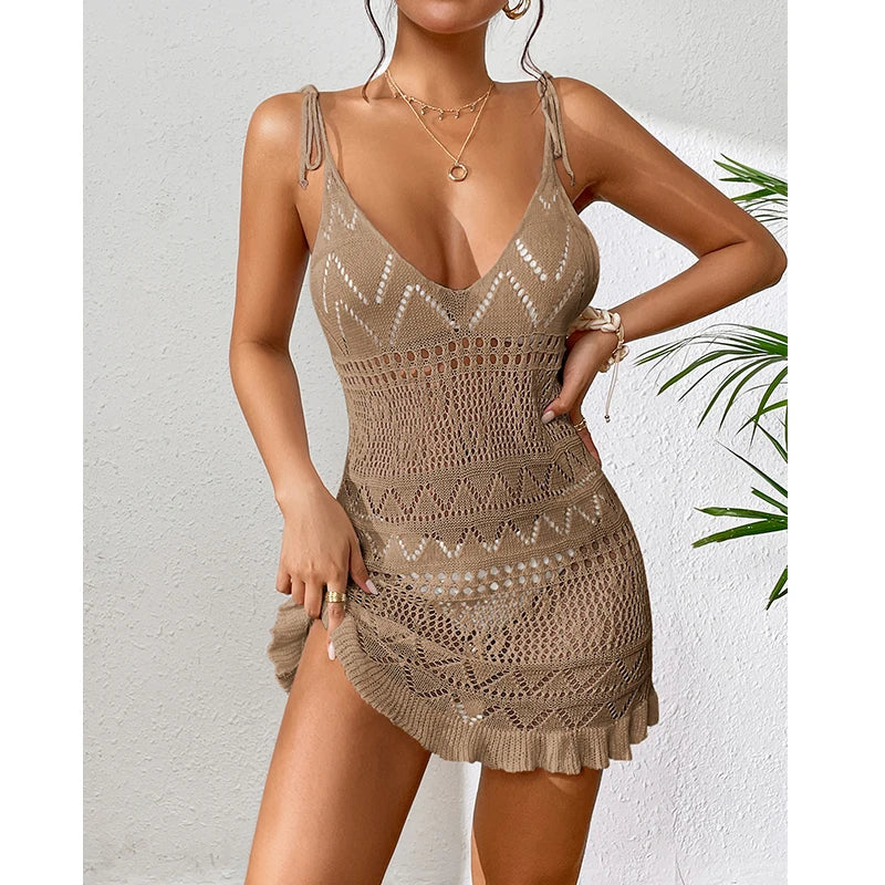 Woman wearing a beige crochet dress against a white background