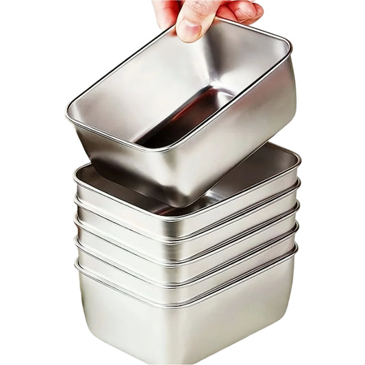 Stack of metal food containers with a hand lifting one, on a kitchen counter.