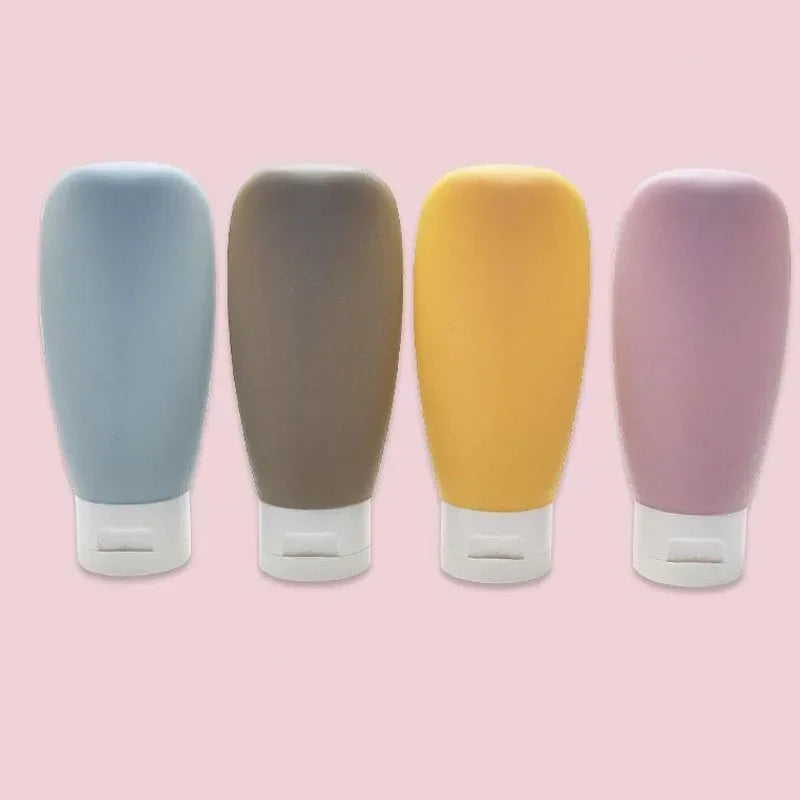 Four cylindrical containers with gradient colors on a pink background