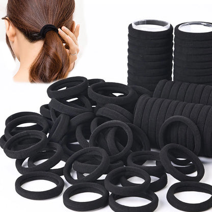 Black hair ties with a person tying their hair, on a white background