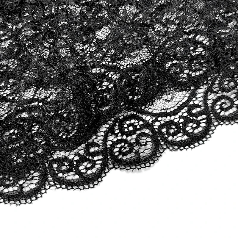Close-up of black lace fabric on a white background