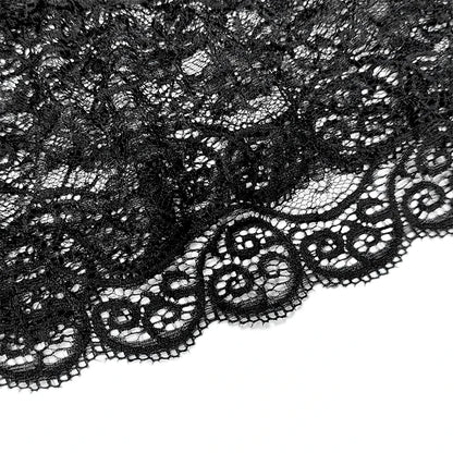 Close-up of black lace fabric on a white background