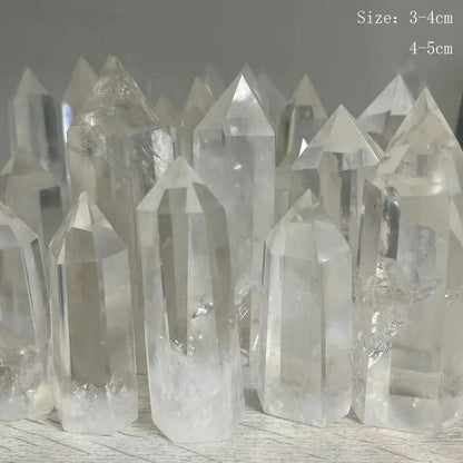 Clear crystal points on a wooden surface with size measurement text.