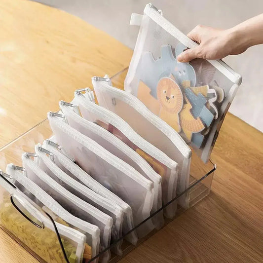 Clear plastic organizer with cartoon-themed pouches on a wooden surface