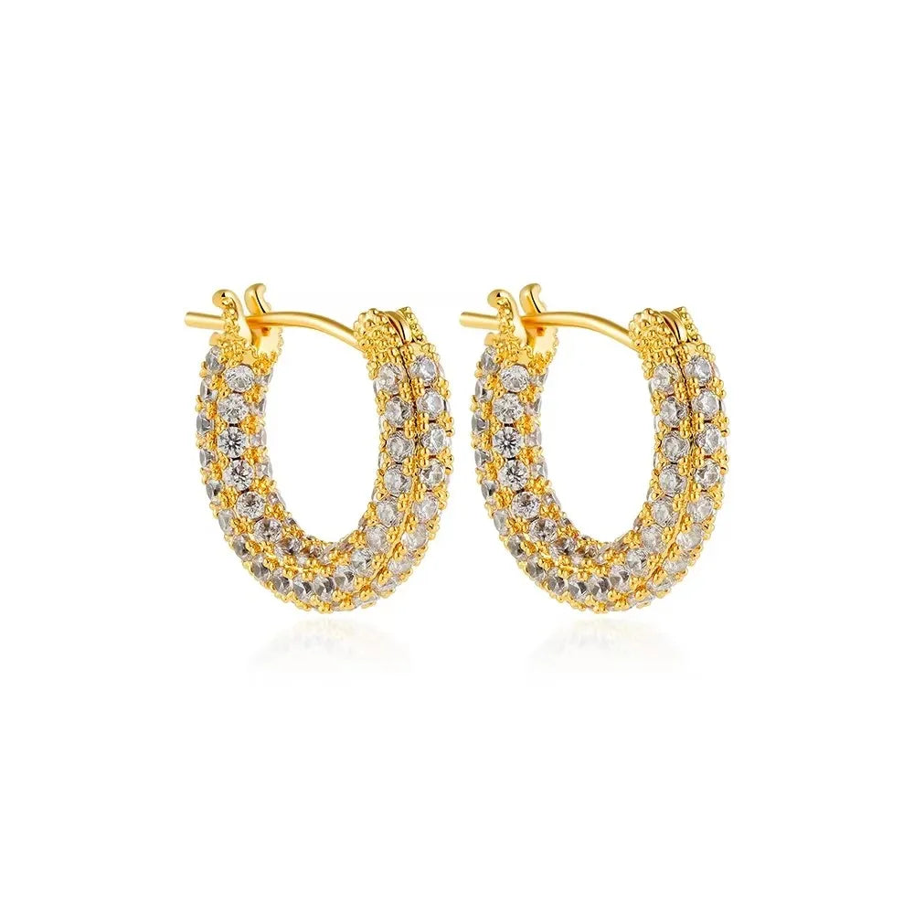 Gold hoop earrings with clear gemstones on a white background