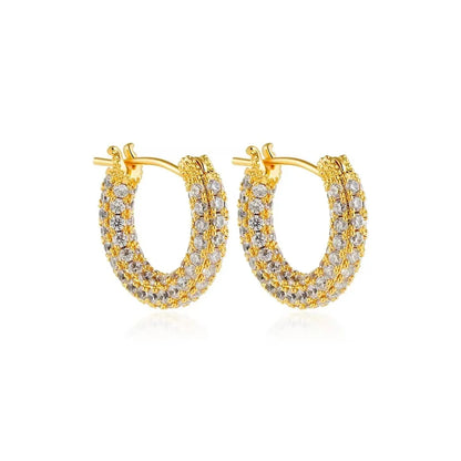 Gold hoop earrings with clear gemstones on a white background
