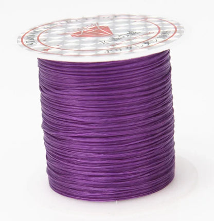 Spool of purple thread on a white background