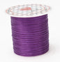 Spool of purple thread on a white background