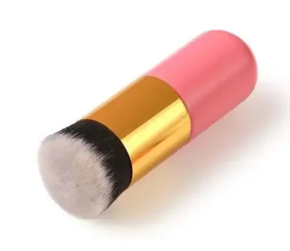 Makeup brush with pink handle and black bristle head on a white background