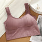 Pink ribbed sports bra on a wooden surface with a magazine and jewelry in the background