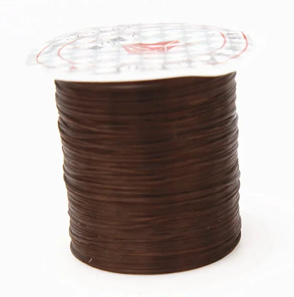 Spool of brown thread on a white background